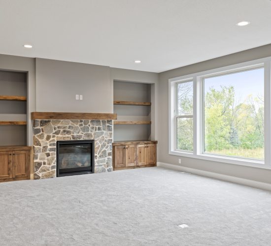 Great room view with fireplace, builtins, and floating shelves