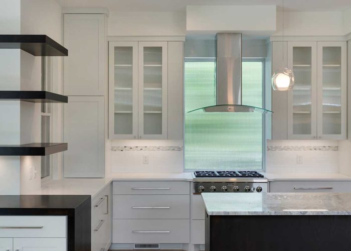 Kitchen with glass cabinets and stainless appliances