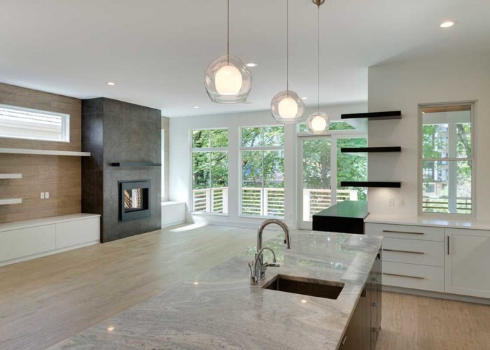 Kitchen with marble countertops and view of living space