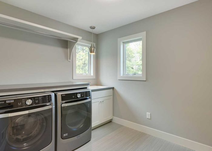 Grey laundry room with washer and dryer unit