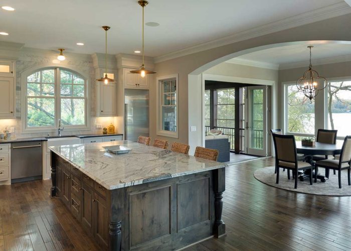 Kitchen space with large marble island and seating