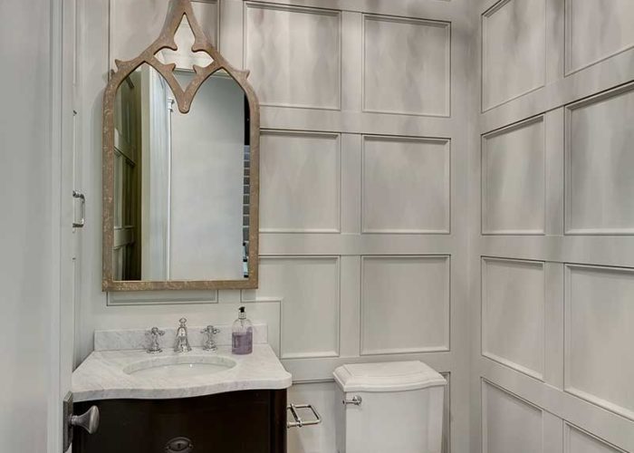 Unique white bathroom with paneled walls