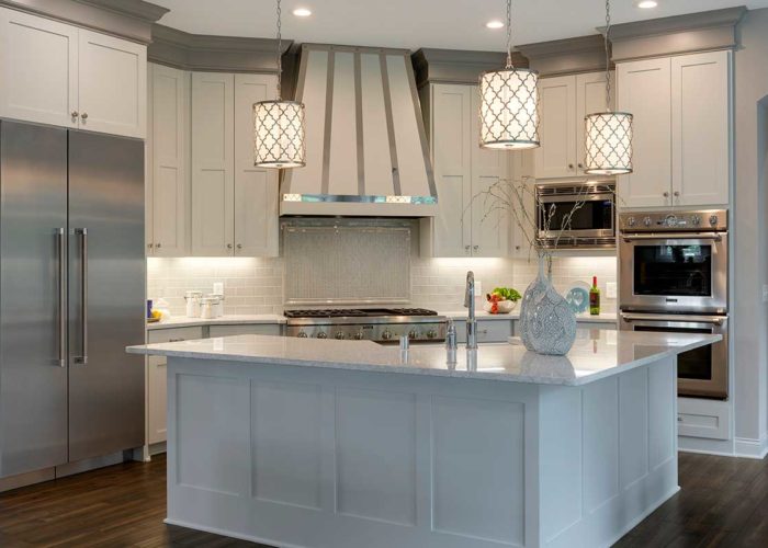 Modern white kitchen with large island with sink