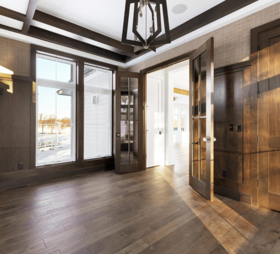 office with wood paneling, built-ins, and beamed ceiling