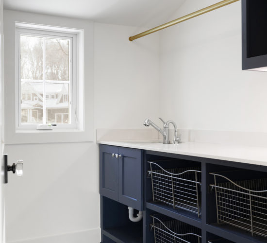 laundry room with blue cabinets and patterned tile flooring