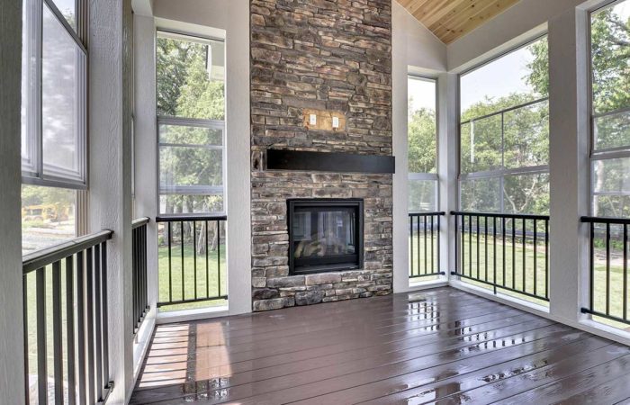 Seasonal porch with stacked brick fireplace