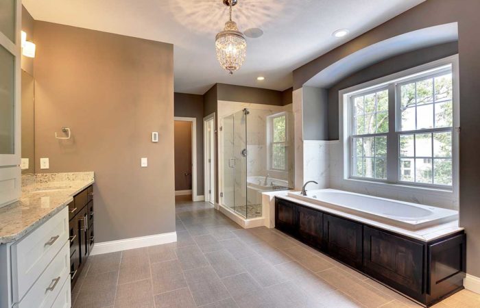 Large bathroom with tub and natural light