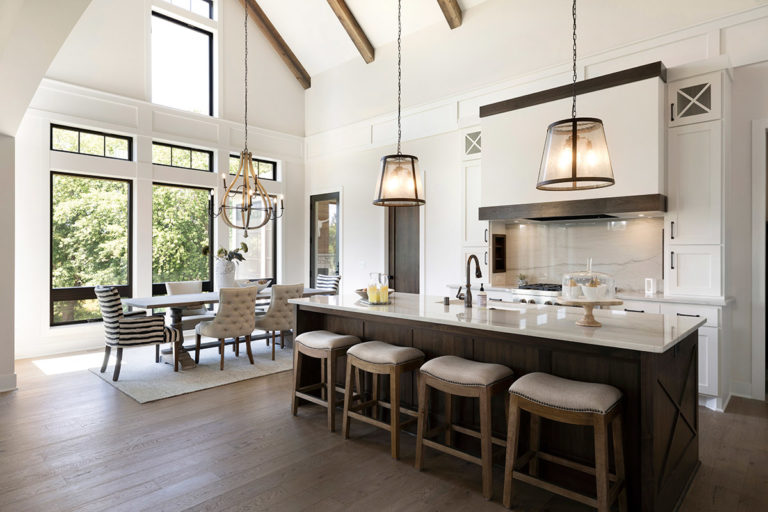 White kitchen with tall ceilings and pendant lighting