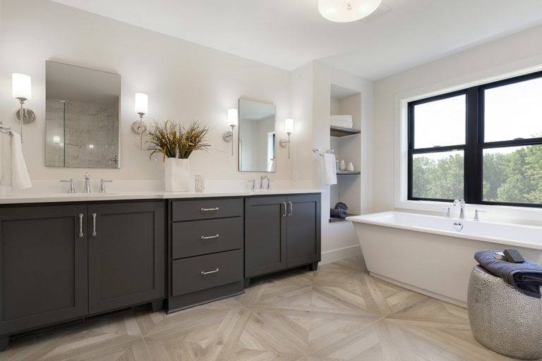 Large bathroom with white walls and dark brown cabinets