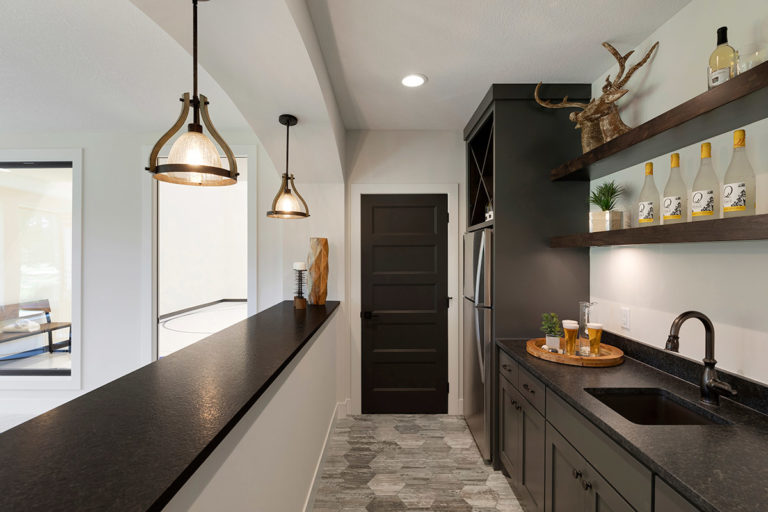 Bar area with dark wood and pendant lighting