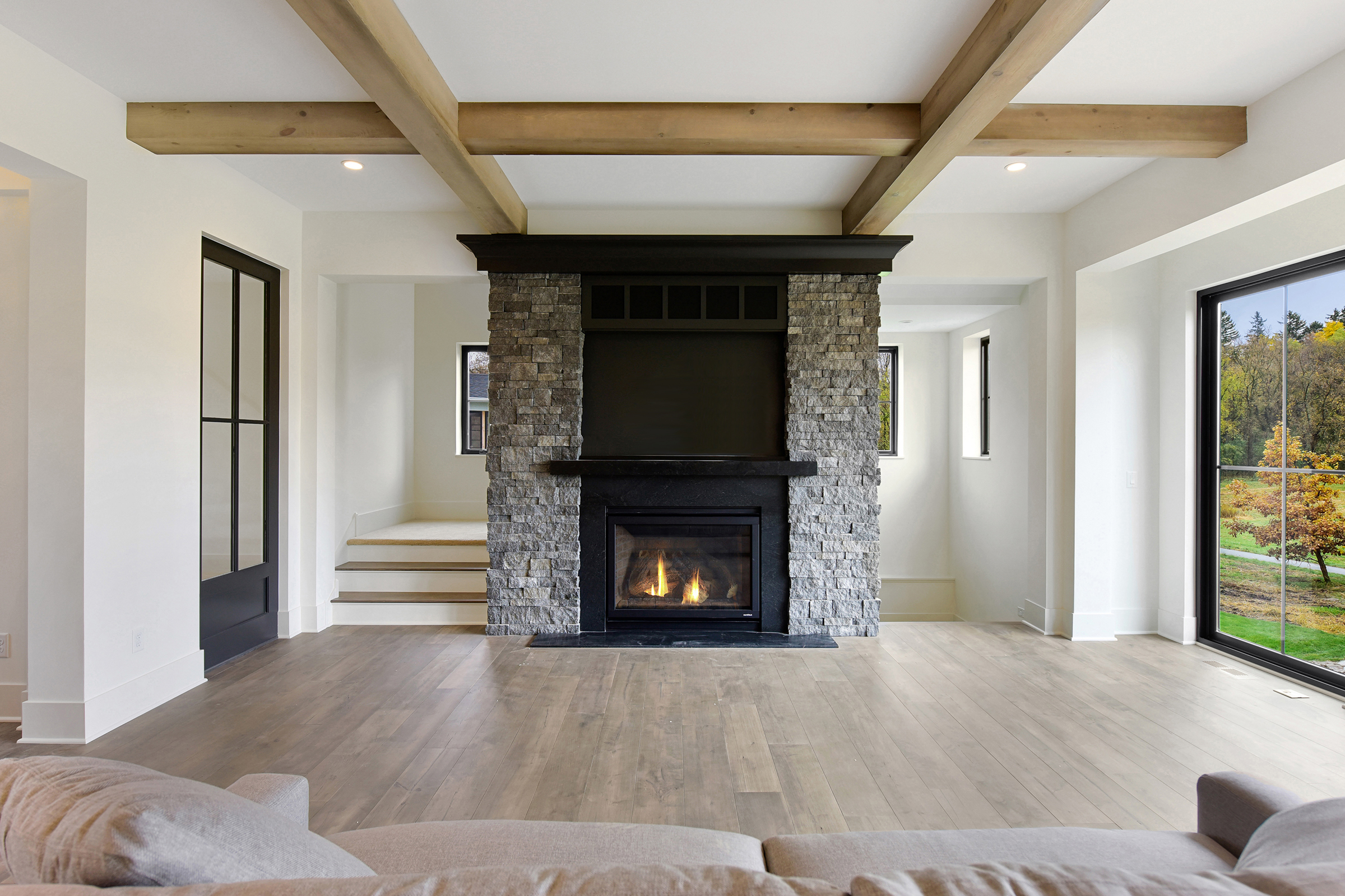 Stone fireplace with black mantle