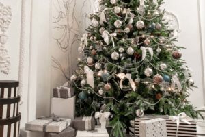 Presents And Gift Boxes Under Christmas Tree. Boxes With Ribbon Bow. New Year Decorated House Interior. Winter Holiday Concept.