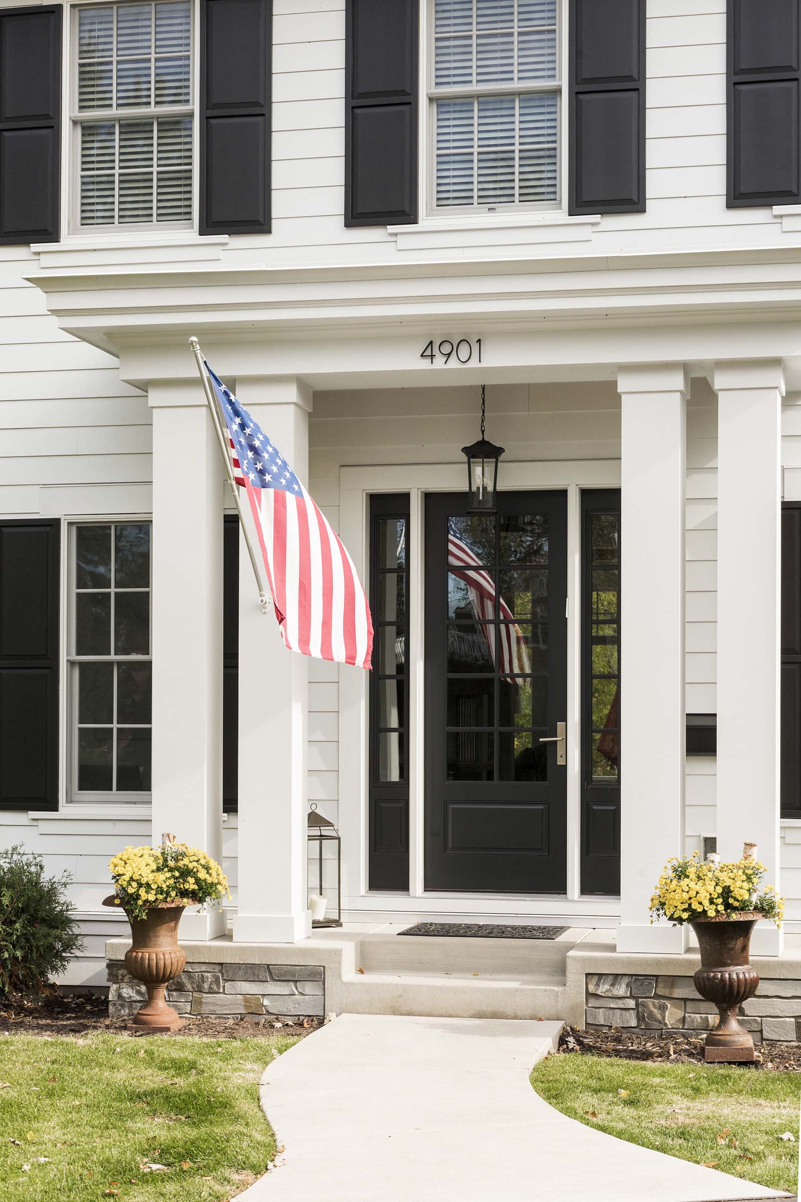 Colonial On The Creek Exterior Entry with white siding and black door and shutters
