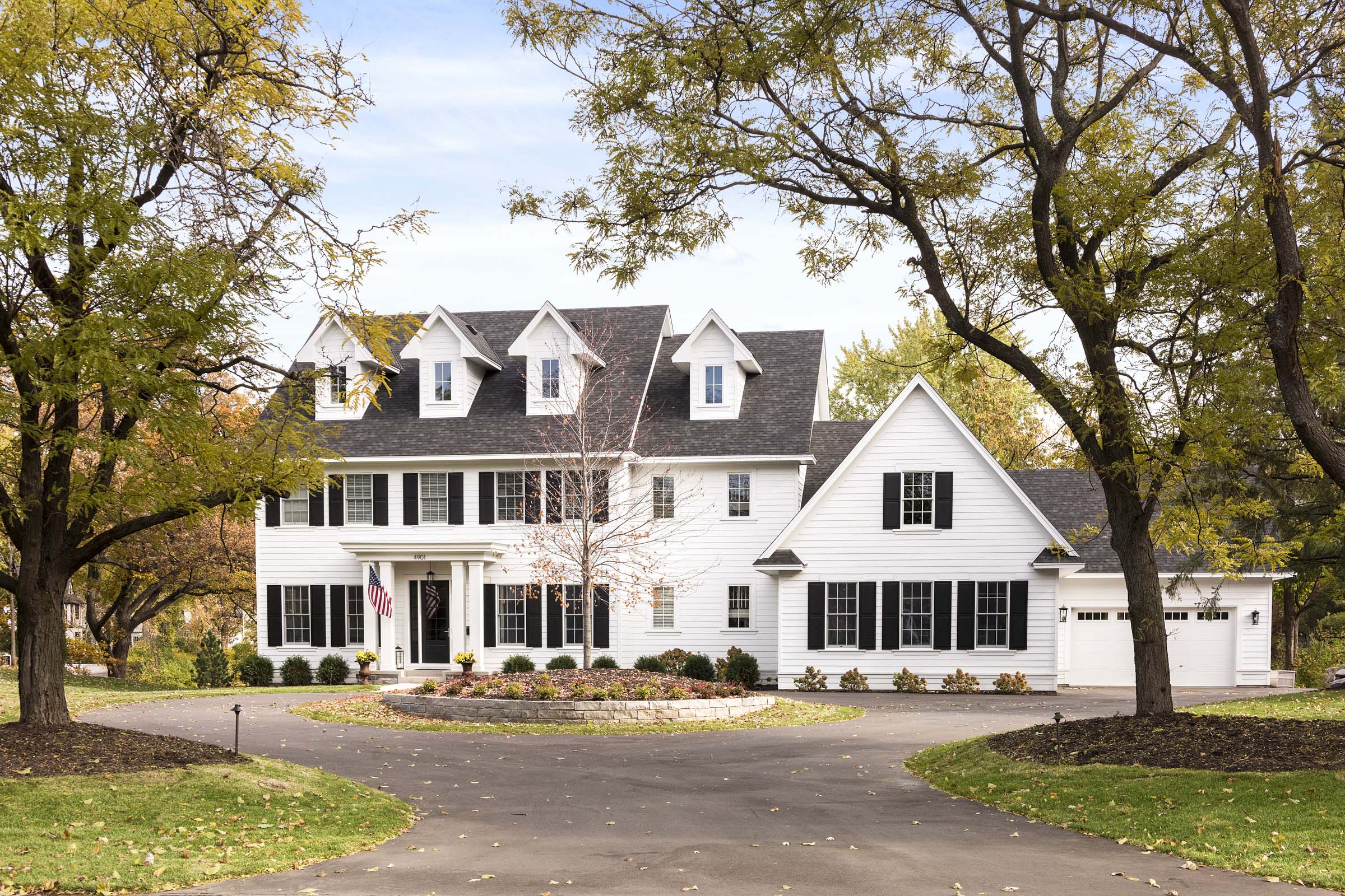 Colonial On The Creek Full Exterior with white siding and black shutters And Driveway