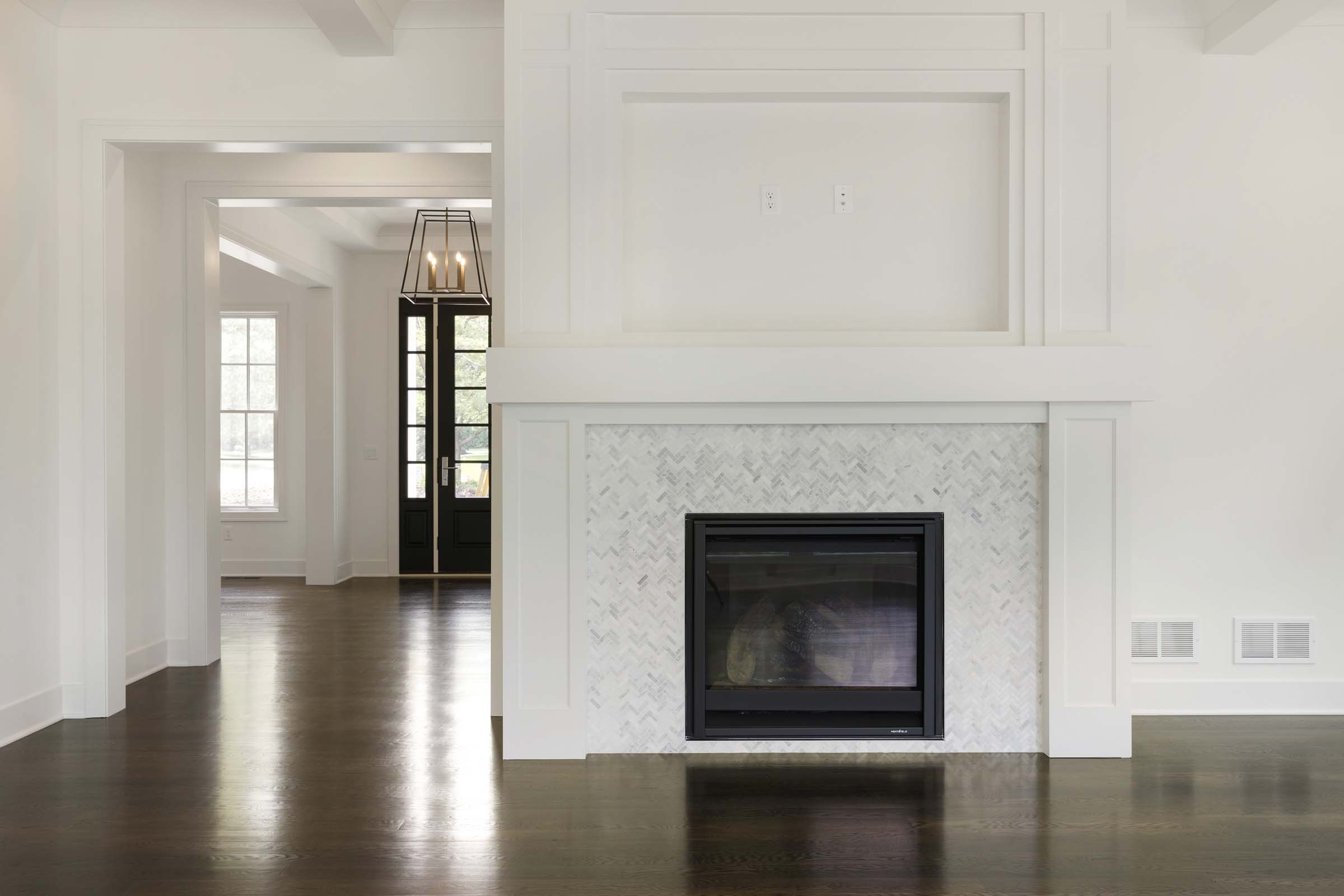 Colonial On The Creek Great Room Fireplace with chevron tile
