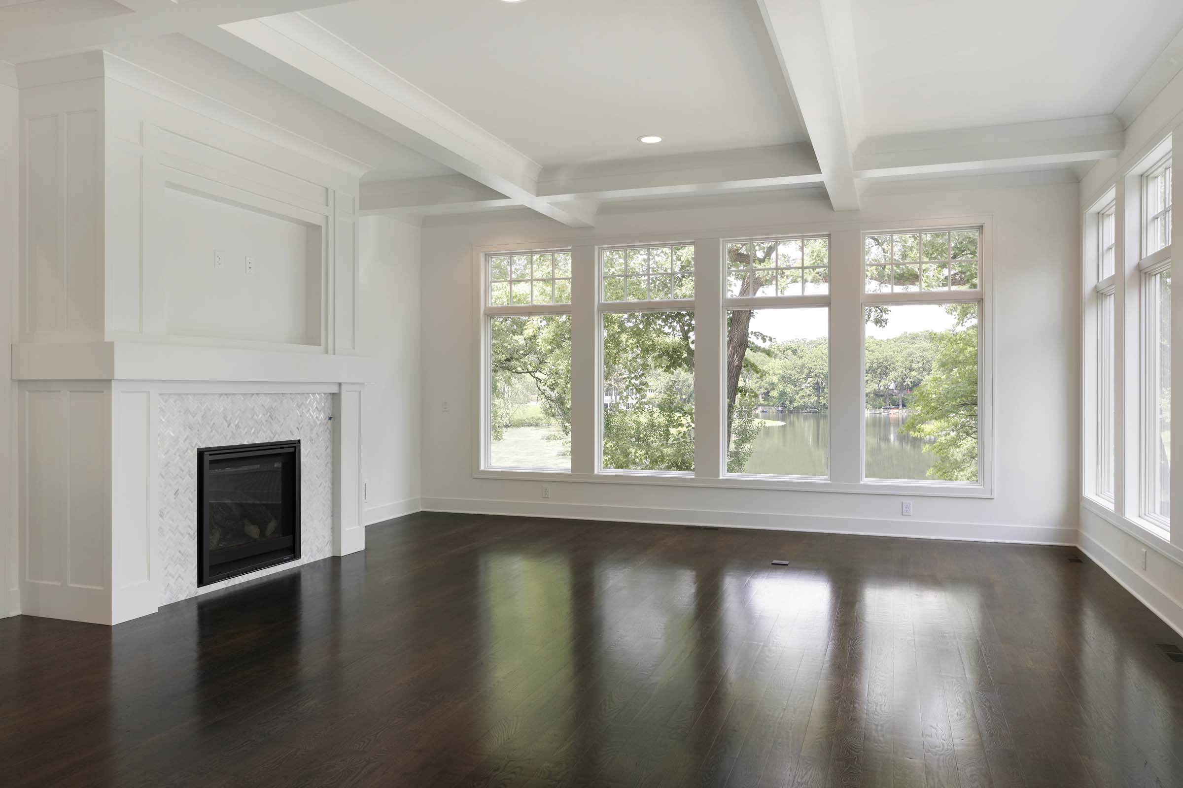 Colonial On The Creek Great Room with tile fireplace and large windows