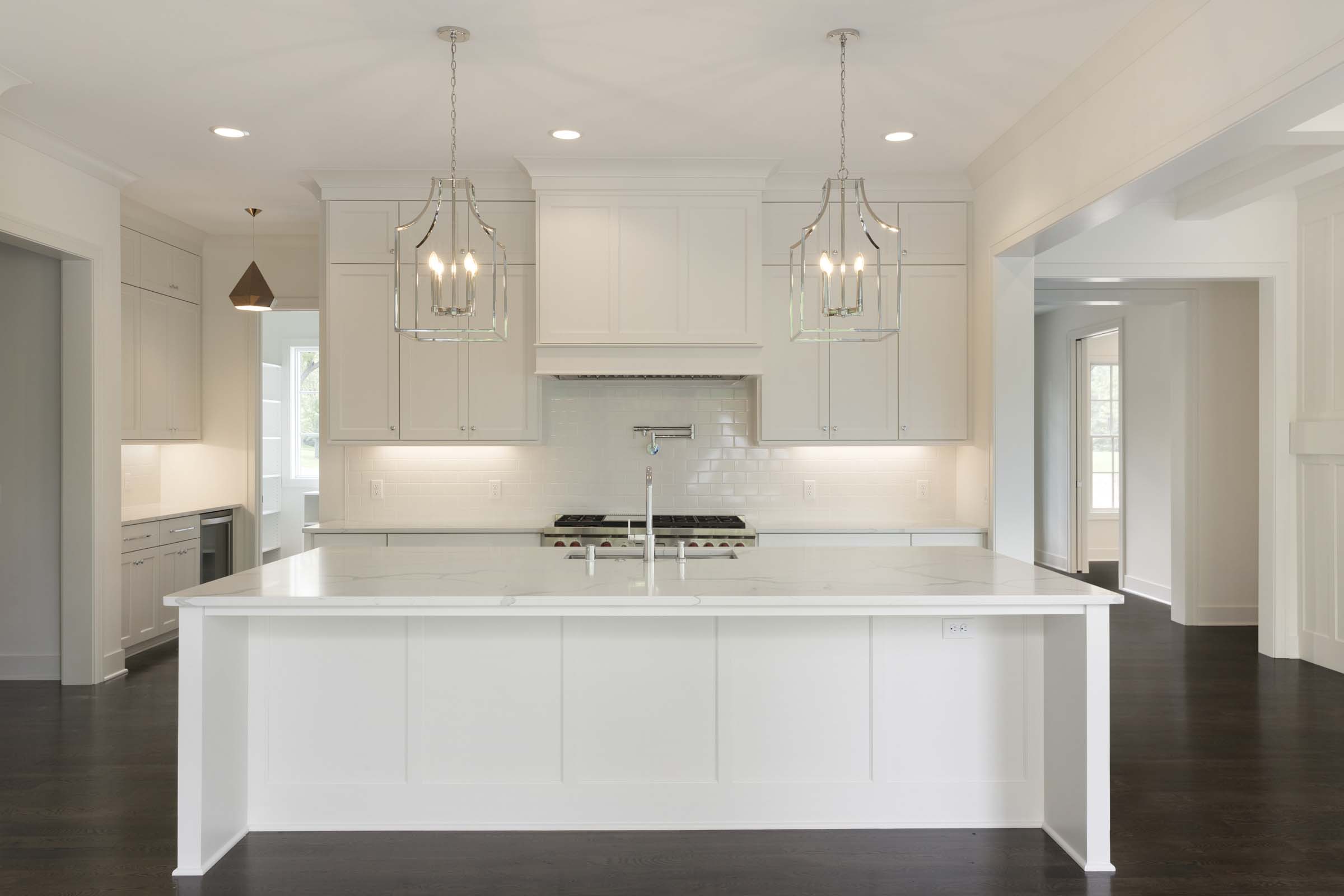 Colonial On The Creek custom white cabinet Kitchen and chrome lighting