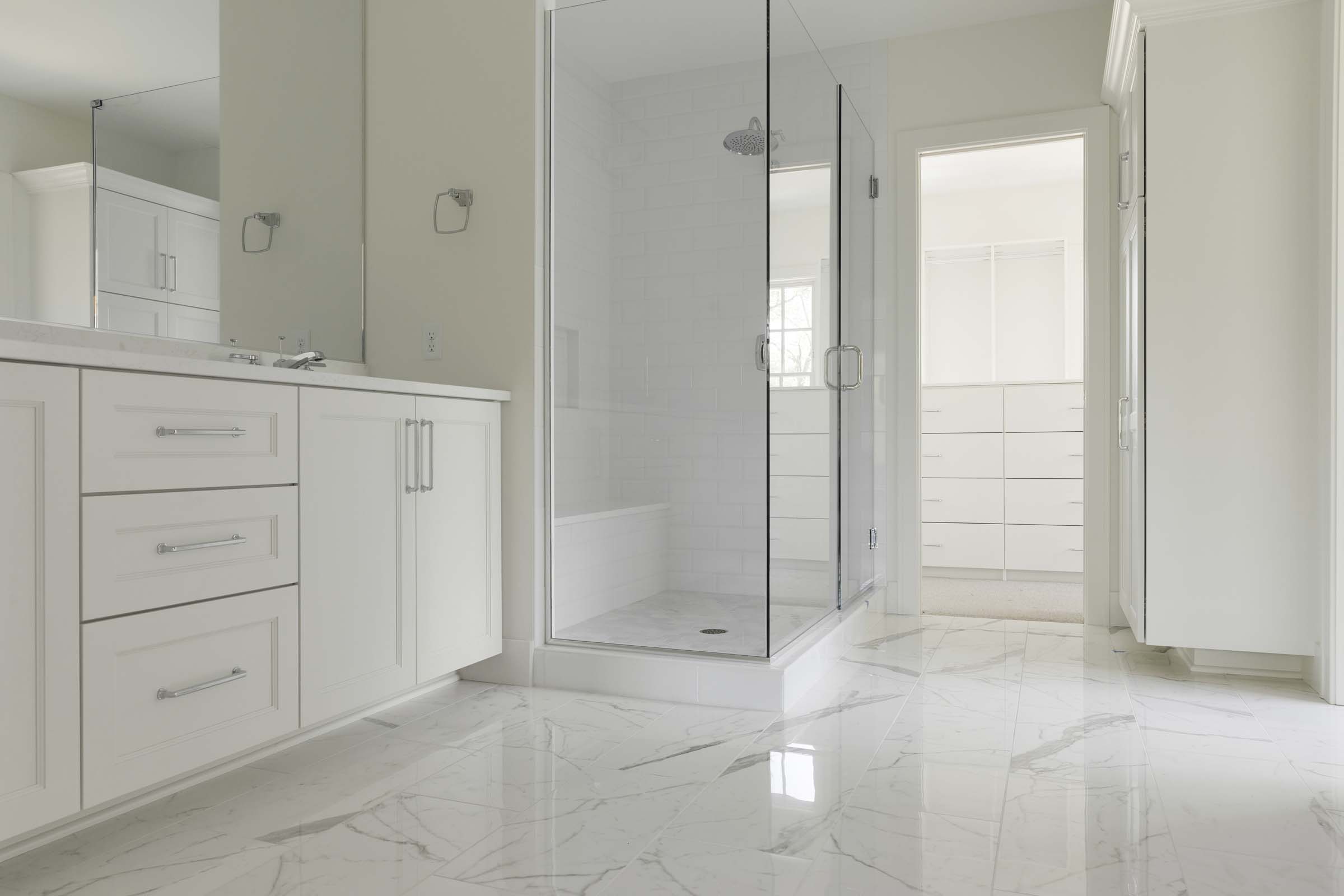 Colonial On The Creek Owners Bath with marble flooring and glass shower