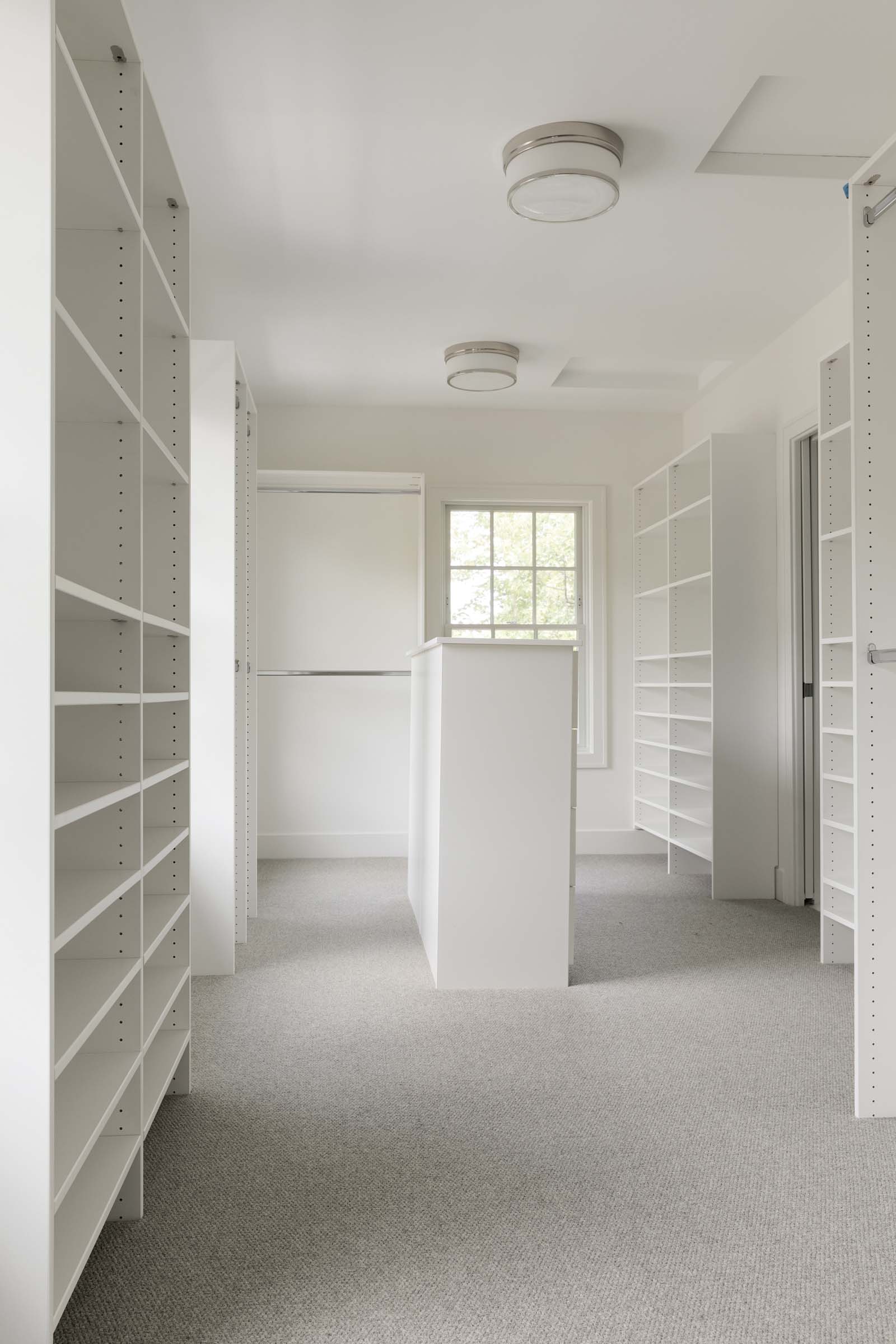 Colonial On The Creek Owners Closet with built-ins and island