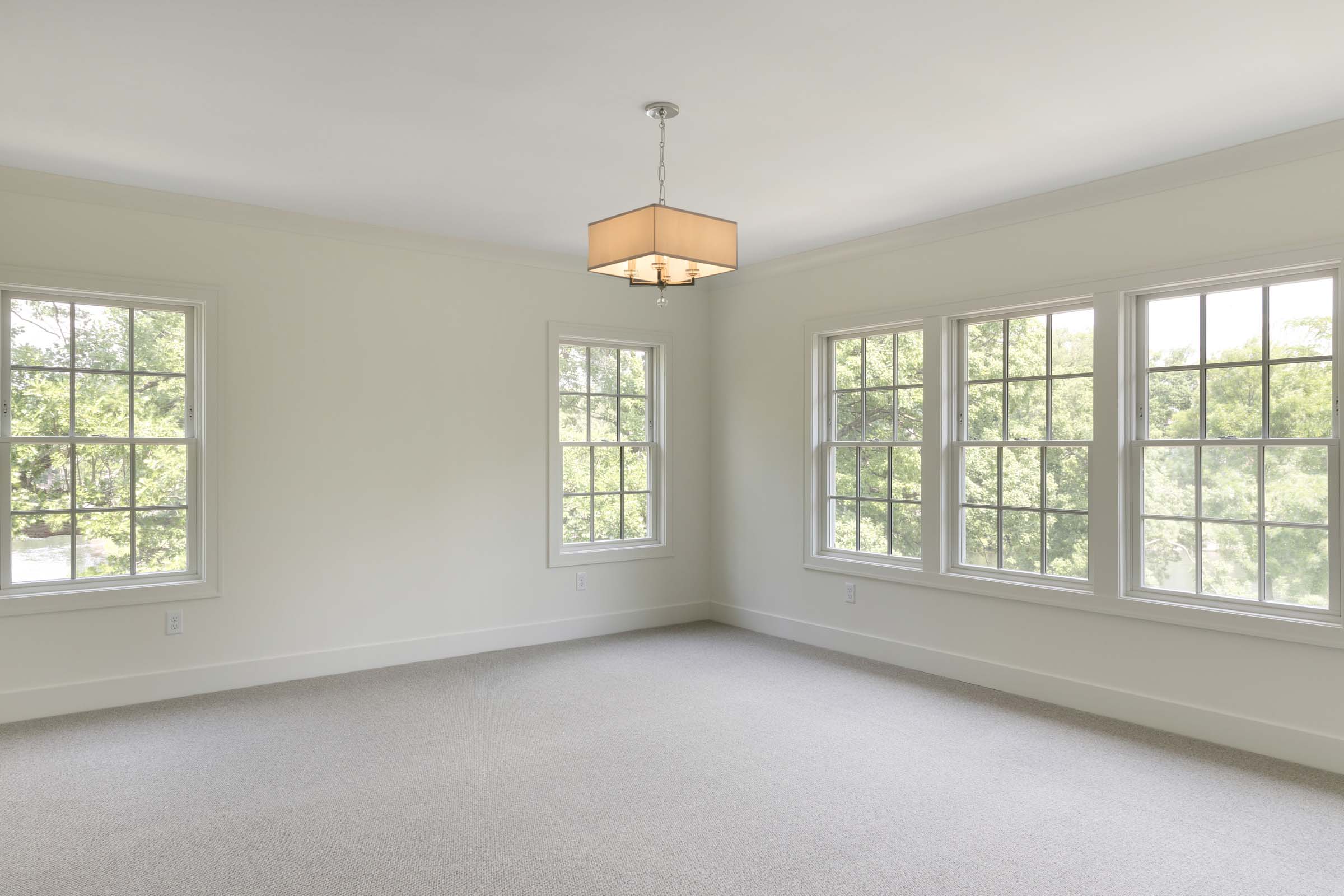 Colonial On The Creek Owners Suite large windows and white walls