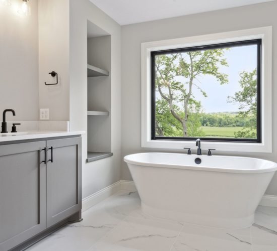 Bathroom with soaking tub by large window
