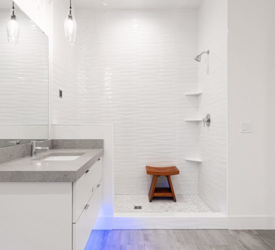 bathroom with titled shower and LED lights