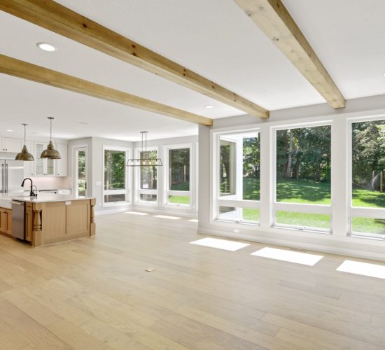view of main level with large windows and beamed ceiling