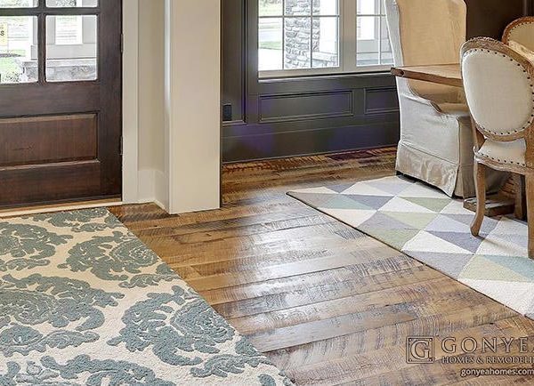 Reclaimed wood floor with rugs