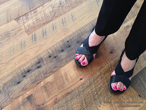 Woman standing on reclaimed wood flooring